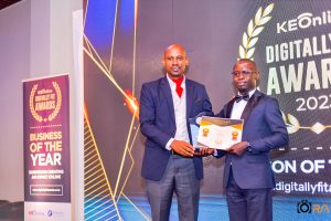Journalist Enock Sikolia presents the Digitally Fit award to Joseph Kokumu